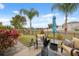 Outdoor patio with comfortable seating and view of the lake and manicured lawn at 18819 Sunterra Dr, Land O Lakes, FL 34638