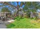 The large backyard features large trees, a shed, a patio, and lots of room for entertaining at 337 Hartwood Ave, Spring Hill, FL 34606