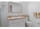 Well-lit bathroom featuring a framed vanity mirror, decorative accessories and neutral color palette at 5548 Cannonade Dr, Wesley Chapel, FL 33544