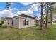 A view of the home's exterior and screened-in porch with lake view at 5548 Cannonade Dr, Wesley Chapel, FL 33544