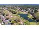 An aerial view showcasing a stunning golf course community with lush greens, a tranquil pond, and well-maintained residences at 5647 Dalton Ct, New Port Richey, FL 34655