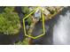 Aerial view showcasing the property's proximity to the water, private dock, and lush surroundings at 5771 Catskill Rd, Holiday, FL 34690