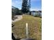 Lush backyard featuring a well-maintained lawn and charming walkway to a serene waterfront at 5771 Catskill Rd, Holiday, FL 34690