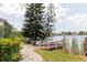Scenic waterfront backyard with a charming walkway and private dock for enjoying lakeside living at 5771 Catskill Rd, Holiday, FL 34690