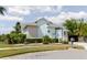 Inviting home with a light blue exterior, manicured lawn, and lovely landscaping, exuding curb appeal at 5771 Catskill Rd, Holiday, FL 34690