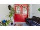Inviting red double front door adorned with wreaths and garland for a warm welcome at 5771 Catskill Rd, Holiday, FL 34690