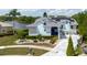 Charming two-story home featuring a well-manicured front yard, lake view, solar panels and inviting entrance at 5771 Catskill Rd, Holiday, FL 34690