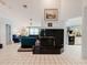 Open-concept living room featuring a black fireplace and tile flooring throughout at 5771 Catskill Rd, Holiday, FL 34690