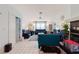 Spacious living room filled with natural light, blue furniture, and a decorative ceiling fan at 5771 Catskill Rd, Holiday, FL 34690