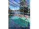 Enclosed pool area with scenic waterfront views and ample space for relaxation and recreation at 5771 Catskill Rd, Holiday, FL 34690