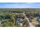 Aerial view of home showcasing its location surrounded by lush greenery and a quiet street at 7482 Winter St, Brooksville, FL 34613