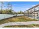 Large backyard featuring a white fence, grassy area, and easy access to screened-in pool at 7482 Winter St, Brooksville, FL 34613