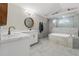 Elegant bathroom featuring dual sinks, a large soaking tub, and modern fixtures at 7482 Winter St, Brooksville, FL 34613
