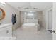 Elegant bathroom featuring a large soaking tub, a glass enclosed shower and double vanity at 7482 Winter St, Brooksville, FL 34613