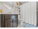 Well-lit bathroom with a granite-topped vanity, modern fixtures, decorative shelves, and a soothing ambiance at 7482 Winter St, Brooksville, FL 34613