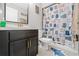 Bright bathroom features a vanity with dark cabinetry, modern fixtures, and a charming cat-themed shower curtain at 7482 Winter St, Brooksville, FL 34613