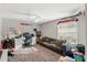 Bedroom with gray walls and carpet includes a desk area, sofa, and ceiling fan at 7482 Winter St, Brooksville, FL 34613