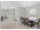 The open dining area has modern light fixtures and white tile floors at 7482 Winter St, Brooksville, FL 34613