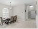 Bright dining area with modern lighting, white tile floor, and lots of natural light at 7482 Winter St, Brooksville, FL 34613