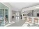 Spacious foyer with ample sunlight, view into the kitchen, and light-colored tile flooring at 7482 Winter St, Brooksville, FL 34613