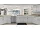 Kitchen area showcases granite countertops, stainless dishwasher, and white cabinets at 7482 Winter St, Brooksville, FL 34613