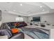 Spacious living room with a large sectional sofa, modern entertainment center, and tray ceiling at 7482 Winter St, Brooksville, FL 34613