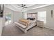 Bright main bedroom featuring a sliding glass door to pool, bench, and an en-suite bathroom at 7482 Winter St, Brooksville, FL 34613