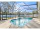 Refreshing screened-in pool surrounded by a patio, ideal for outdoor relaxation and entertaining in a private setting at 7482 Winter St, Brooksville, FL 34613