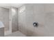 Spacious walk-in shower featuring tiled walls, shower head and small window at 7482 Winter St, Brooksville, FL 34613