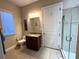 Well-appointed bathroom featuring a vanity with granite countertop and glass-enclosed shower at 1421 Apollo Beach Blvd, Apollo Beach, FL 33572