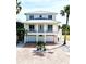 Stunning two-story home with a brick driveway, multiple car garage, and a charming balcony at 1421 Apollo Beach Blvd, Apollo Beach, FL 33572