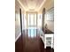 Inviting hallway with hardwood floors, decorative lighting, and elegant archway details at 1421 Apollo Beach Blvd, Apollo Beach, FL 33572