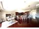 Spacious living room featuring hardwood floors, bar seating, dining area, and cherry wood cabinets at 1421 Apollo Beach Blvd, Apollo Beach, FL 33572