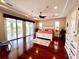 This main bedroom boasts hardwood floors, natural light, and access to an outdoor patio at 1421 Apollo Beach Blvd, Apollo Beach, FL 33572