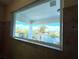 Picture window view of the neighborhood waterway, palm trees, and sky at 1421 Apollo Beach Blvd, Apollo Beach, FL 33572