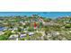 Breathtaking aerial view showcasing lush trees and a beautiful blue waterfront at 1888 Douglas Ave, Dunedin, FL 34698