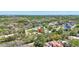 A home's location is highlighted in this aerial view, surrounded by a canopy of trees in a quiet neighborhood at 1888 Douglas Ave, Dunedin, FL 34698