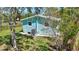 Backyard of home with lush green grass and shade with fenced-in yard at 1888 Douglas Ave, Dunedin, FL 34698