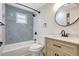 Renovated bathroom featuring modern fixtures, sleek tile, and a wood vanity at 1888 Douglas Ave, Dunedin, FL 34698