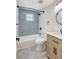 Renovated bathroom featuring stylish blue tiling, a vanity, and modern fixtures in a neutral color palette at 1888 Douglas Ave, Dunedin, FL 34698