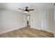 Spacious bedroom with a ceiling fan, wood floors, and neutral paint colors at 1888 Douglas Ave, Dunedin, FL 34698