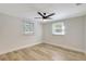 Bright bedroom with two windows, neutral walls, and sleek light-colored flooring, creating a serene space at 1888 Douglas Ave, Dunedin, FL 34698
