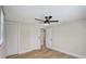 Bedroom with light-colored walls and flooring, a modern ceiling fan, and views into another room at 1888 Douglas Ave, Dunedin, FL 34698