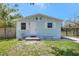 Charming home with white door and shutters, well-maintained front yard, and black iron fence at 1888 Douglas Ave, Dunedin, FL 34698