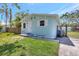 Charming home with white door and shutters, well-maintained front yard, and wood and iron fence at 1888 Douglas Ave, Dunedin, FL 34698