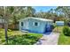 Charming single-story home featuring a well-manicured lawn, white-trimmed windows, and a cozy front entrance at 1888 Douglas Ave, Dunedin, FL 34698