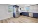 Charming kitchen with stainless appliances, two-tone cabinets, and wood flooring at 1888 Douglas Ave, Dunedin, FL 34698