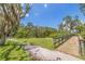 Scenic view of a walking path and bridge surrounded by lush greenery and trees under a blue sky at 1888 Douglas Ave, Dunedin, FL 34698