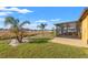 Expansive backyard with tropical landscaping, covered patio, and plenty of space for outdoor enjoyment at 2109 Trillium Blvd, Brooksville, FL 34604