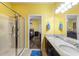 Bright bathroom features double vanity, granite counters and a glass-enclosed shower at 2109 Trillium Blvd, Brooksville, FL 34604